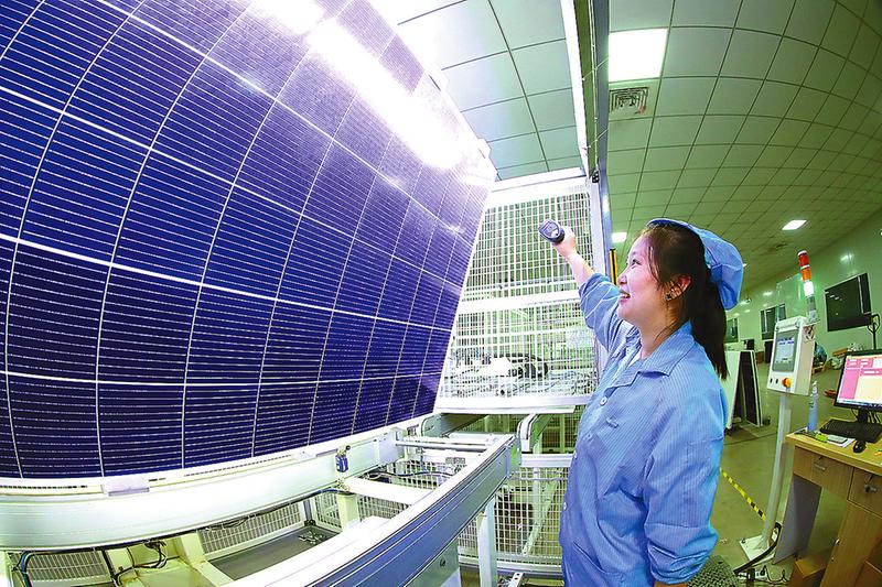 周庄科技产业园内工人们正在组装太阳能电池板