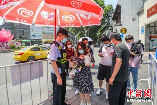 “五一”期间，夫子庙景区出入口，游客持健康码“绿码”，测量体温后入内游览。 南报融媒体记者 董家训 摄